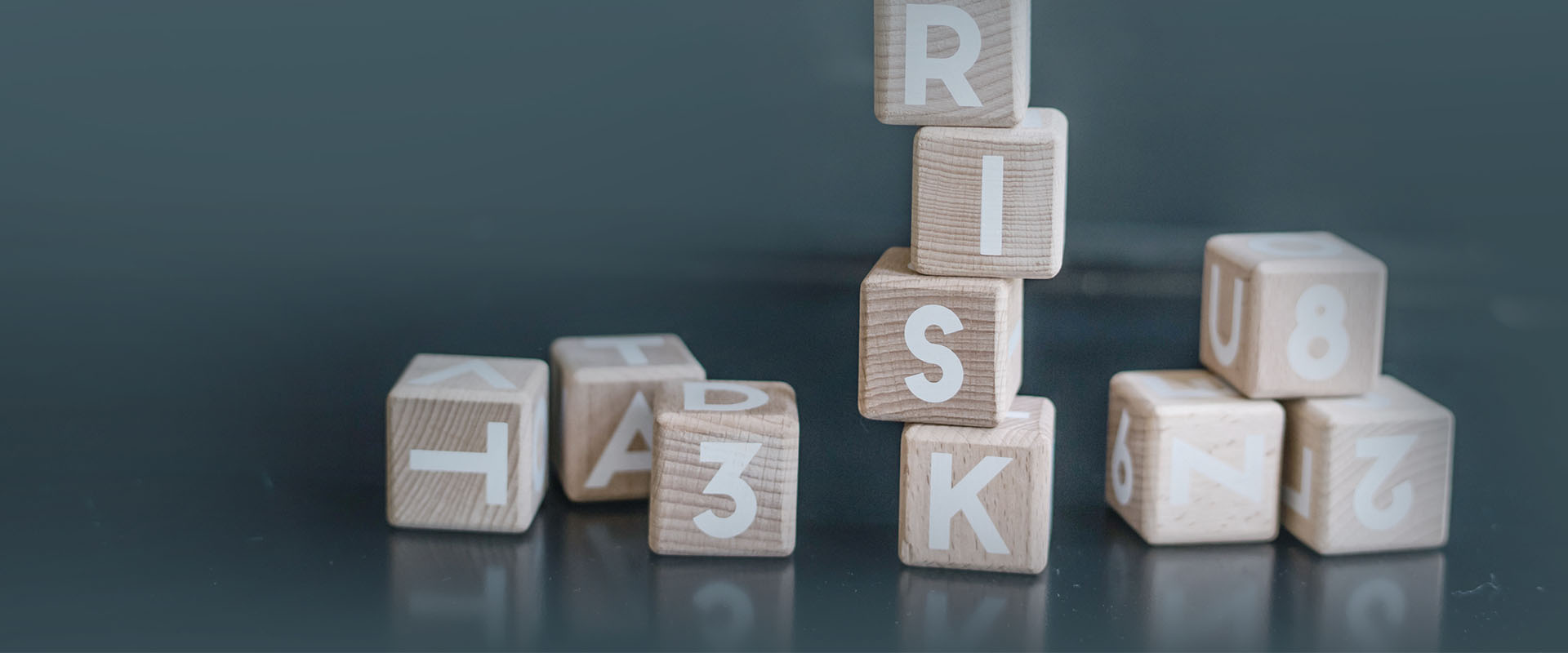 Stack of blocks spelling the word 'Risk'